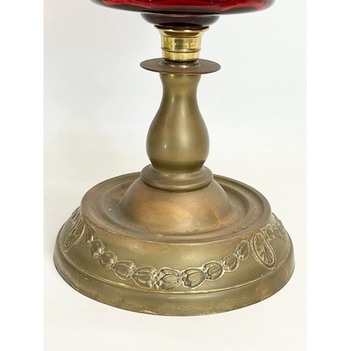 280N - A Victorian Ruby Glass and brass double burner oil lamp. 60cm