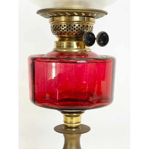 280N - A Victorian Ruby Glass and brass double burner oil lamp. 60cm