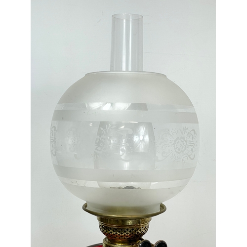 280N - A Victorian Ruby Glass and brass double burner oil lamp. 60cm