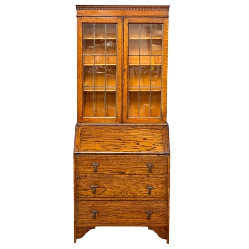 150 - A 1930’s oak bureau bookcase. 75x43x185.5cm