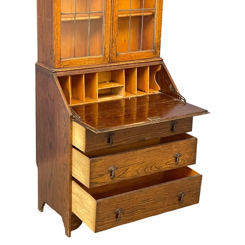 150 - A 1930’s oak bureau bookcase. 75x43x185.5cm