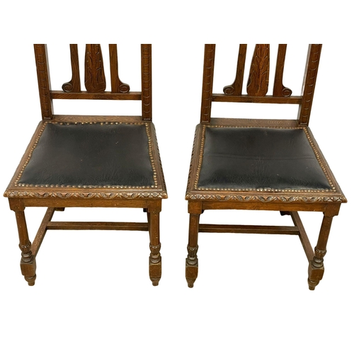 204 - A pair of late 19th century carved oak high back side chairs with leather seats and backs. Circa 189... 