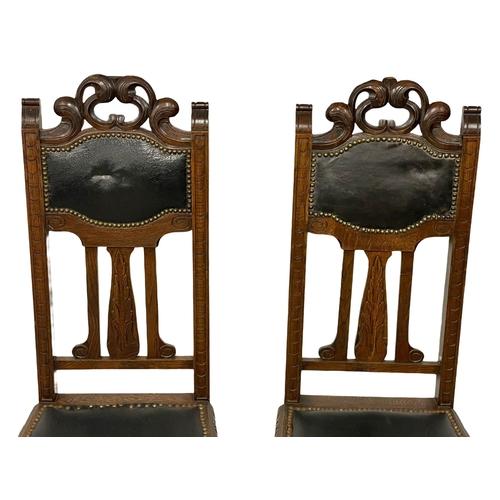 204 - A pair of late 19th century carved oak high back side chairs with leather seats and backs. Circa 189... 