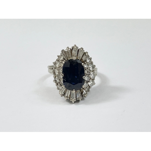 598B - An excellent quality 18ct gold sapphire and diamond cluster ring. Central oval cut sapphire calculat... 