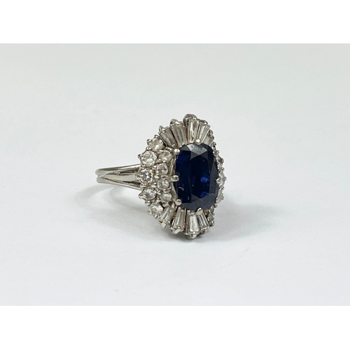 598B - An excellent quality 18ct gold sapphire and diamond cluster ring. Central oval cut sapphire calculat... 