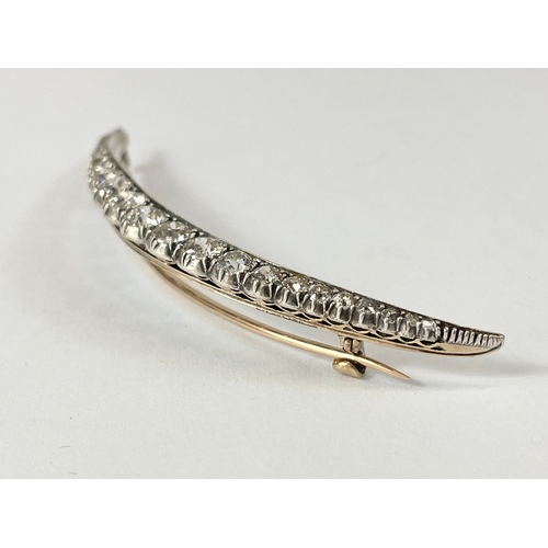 598C - An excellent quality 18ct gold diamond crescent brooch. 23 old cut diamonds from 1.5mm to 4.7mm. Tot... 