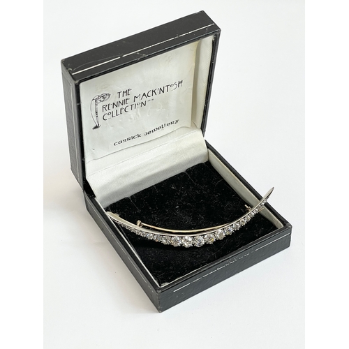 598C - An excellent quality 18ct gold diamond crescent brooch. 23 old cut diamonds from 1.5mm to 4.7mm. Tot... 