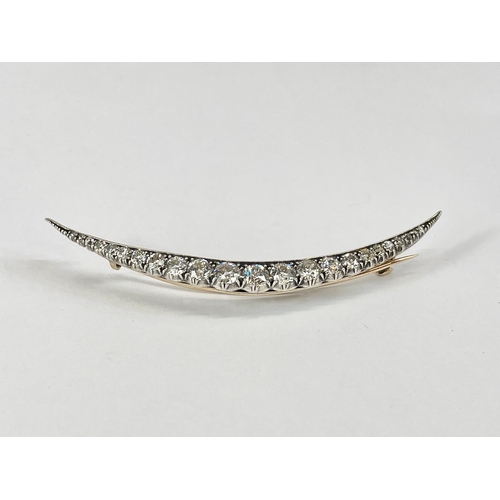 598C - An excellent quality 18ct gold diamond crescent brooch. 23 old cut diamonds from 1.5mm to 4.7mm. Tot... 