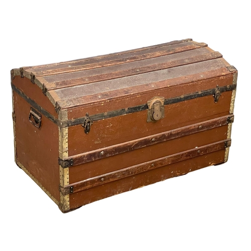 247D - An early 20th century dome top trunk. 91x52x55.5cm