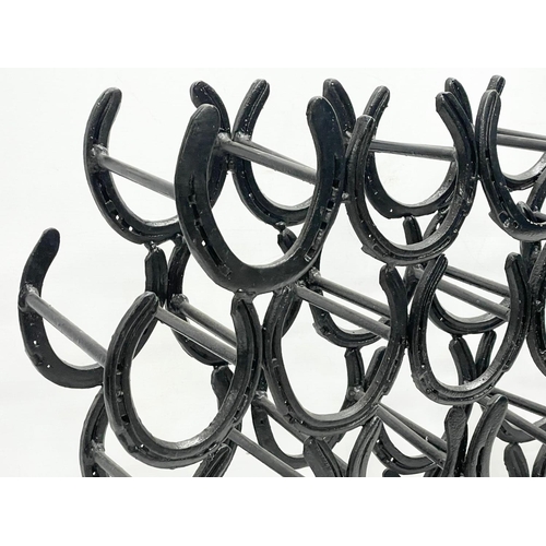 280E - A large horse shoe wine rack. 99x20x53cm