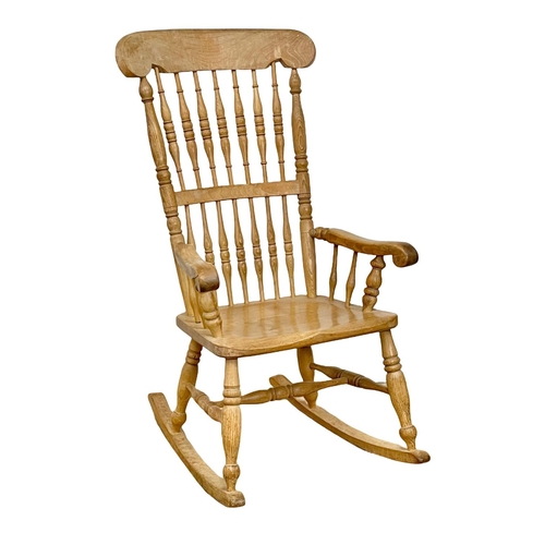 1076 - An early 20th century Elm and Beech rocking chair.