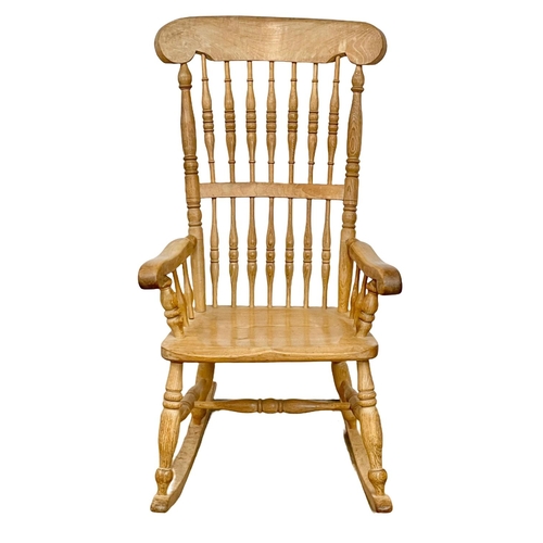 1076 - An early 20th century Elm and Beech rocking chair.