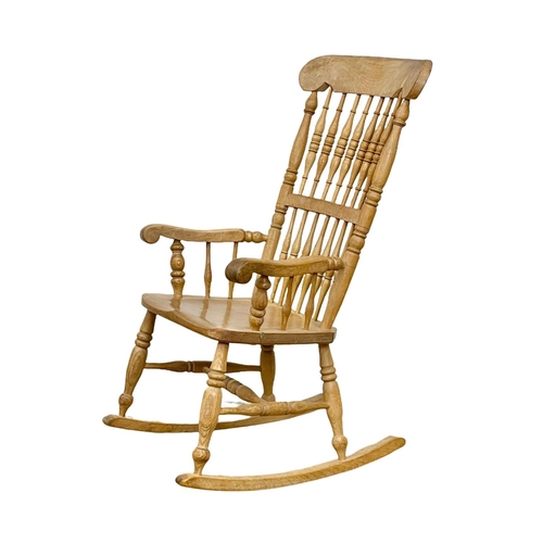 1076 - An early 20th century Elm and Beech rocking chair.