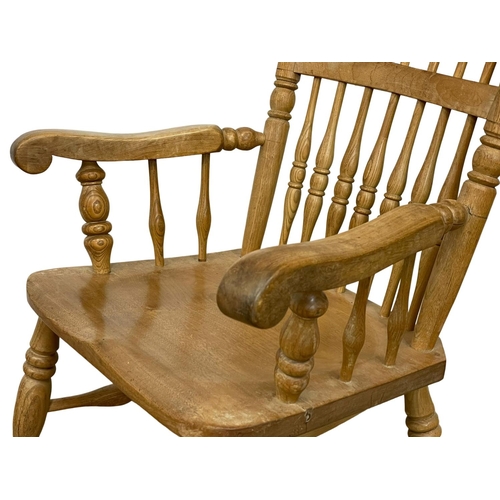 1076 - An early 20th century Elm and Beech rocking chair.