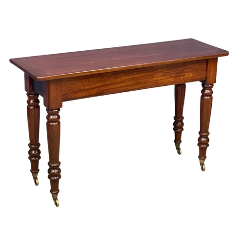 1077 - A large Victorian mahogany side table on brass cup casters 121.5x40x75.5cm