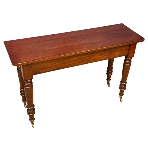 1077 - A large Victorian mahogany side table on brass cup casters 121.5x40x75.5cm