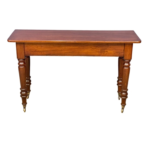 1077 - A large Victorian mahogany side table on brass cup casters 121.5x40x75.5cm