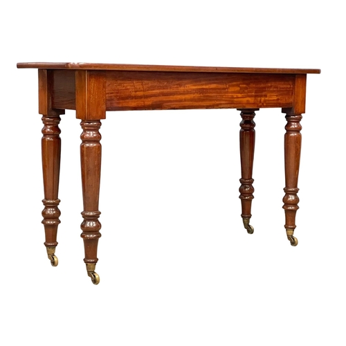 1077 - A large Victorian mahogany side table on brass cup casters 121.5x40x75.5cm