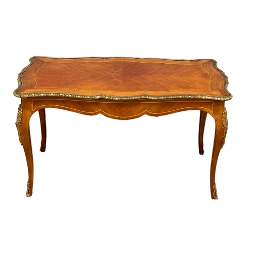 1091 - A good quality French inlaid coffee table with ornate brass Ormolu mounts. 96x58.5x50.5cm