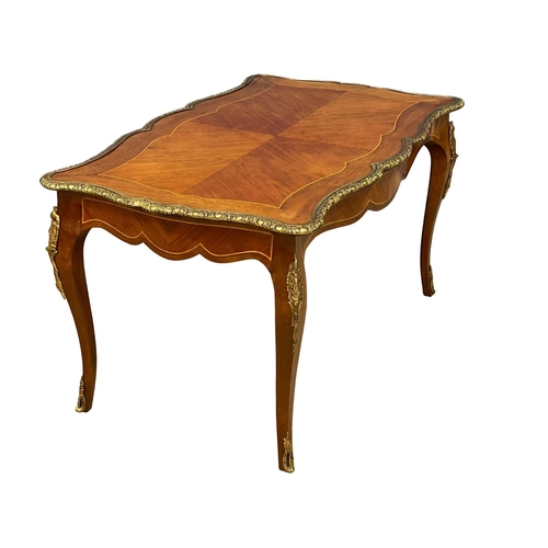 1091 - A good quality French inlaid coffee table with ornate brass Ormolu mounts. 96x58.5x50.5cm