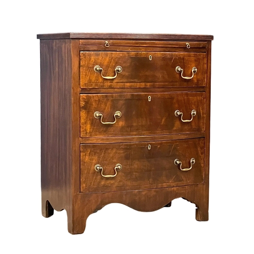 1095 - A vintage Georgian style mahogany bow front chest of drawers, with brushing slide and brass drop han... 