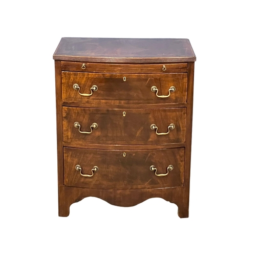 1095 - A vintage Georgian style mahogany bow front chest of drawers, with brushing slide and brass drop han... 