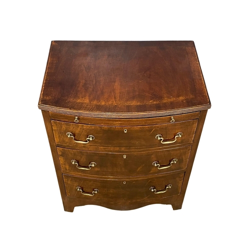 1095 - A vintage Georgian style mahogany bow front chest of drawers, with brushing slide and brass drop han... 