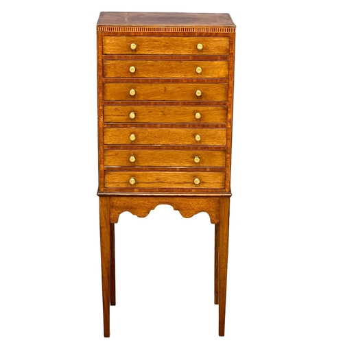 1098 - An Edwardian inlaid mahogany multi drawer chest. 40x25x98.5cm