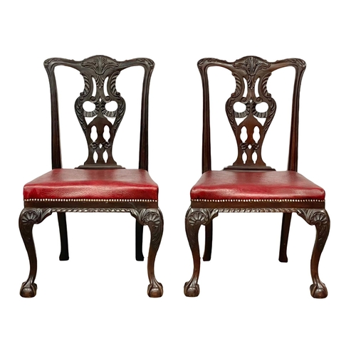 1109 - A pair of good quality early 20th century Irish Chippendale Revival mahogany chairs, with leather se... 