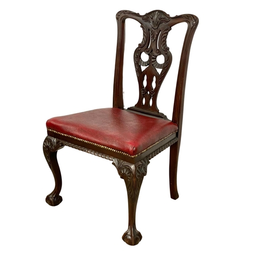 1109 - A pair of good quality early 20th century Irish Chippendale Revival mahogany chairs, with leather se... 