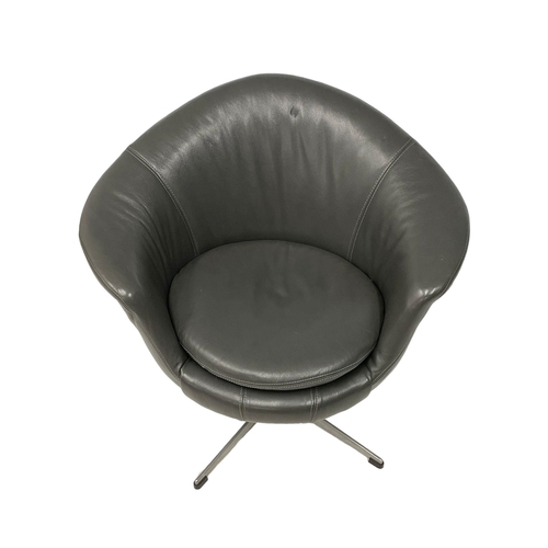 1111 - A vintage Arne Jacobsen style leather swivel egg chair on chrome base.