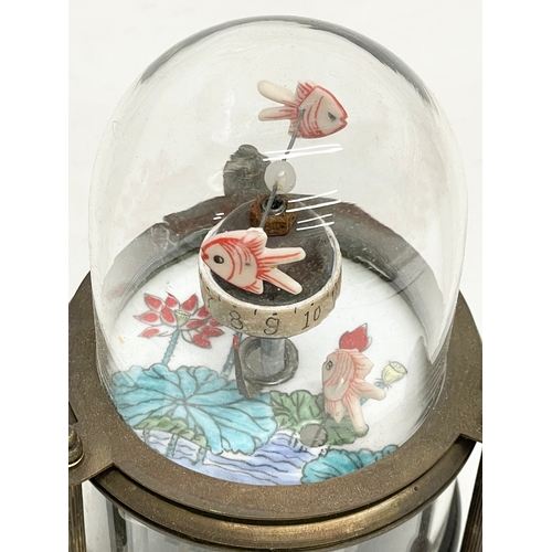 603 - A novelty clockwork automaton brass fish tank clock with glass dome. 15cm