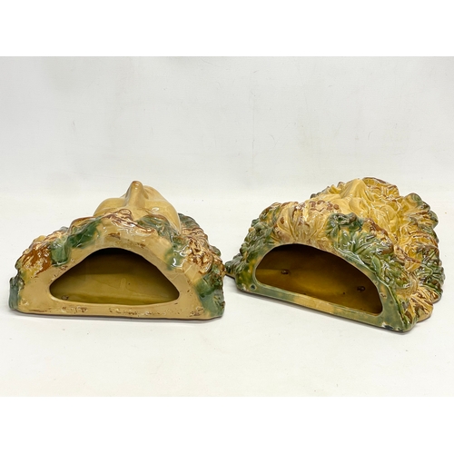 604 - A pair of large Majolica style terracotta wall planters. 33x38cm