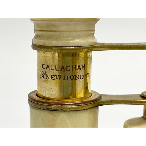 93 - A set of early 20th century bone and brass opera glasses in case by Callaghan of London.