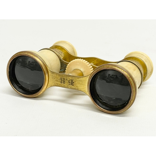 93 - A set of early 20th century bone and brass opera glasses in case by Callaghan of London.