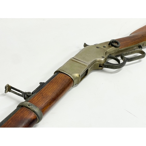 104 - A good quality replica Winchester rifle with wall mounted stand. Rifle measures 99.5cm