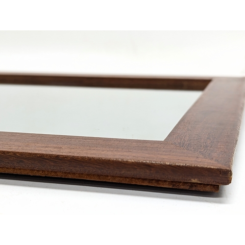 127 - A Mid Century teak framed mirror. 74.5x32.5cm