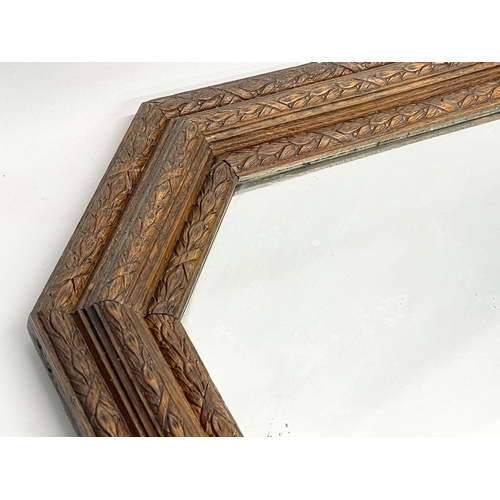 220 - An early 20th century ornate oak framed mirror. Circa 1900-1920. 64x54cm