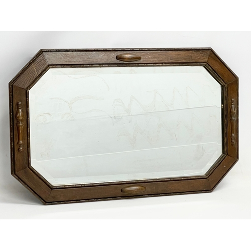 574 - A 1920’s oak frame bevelled mirror. 80x50cm