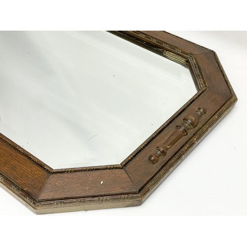 574 - A 1920’s oak frame bevelled mirror. 80x50cm