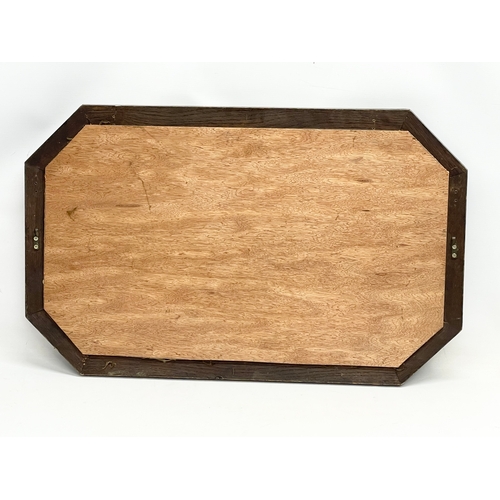 574 - A 1920’s oak frame bevelled mirror. 80x50cm