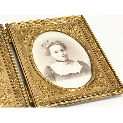 11 - A Victorian ornate brass double photo frame. 25.5x16.5cm