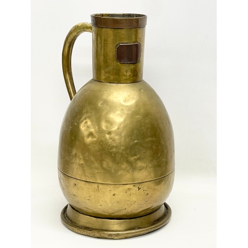 638 - A large 19th century brass jug. Stamped E. Tits and T. Vaks. 26x41cm