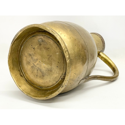 638 - A large 19th century brass jug. Stamped E. Tits and T. Vaks. 26x41cm