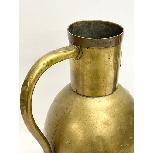 638 - A large 19th century brass jug. Stamped E. Tits and T. Vaks. 26x41cm