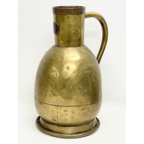 638 - A large 19th century brass jug. Stamped E. Tits and T. Vaks. 26x41cm