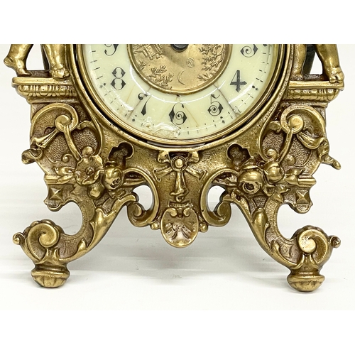 20 - An early 20th century ornate brass windup mantle clock with enamel and brass face and cherub decorat... 