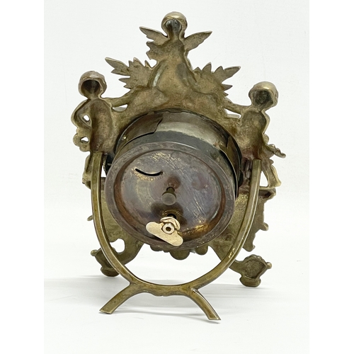 20 - An early 20th century ornate brass windup mantle clock with enamel and brass face and cherub decorat... 