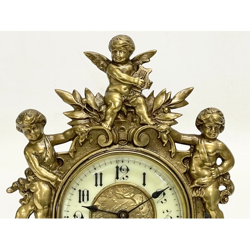 20 - An early 20th century ornate brass windup mantle clock with enamel and brass face and cherub decorat... 