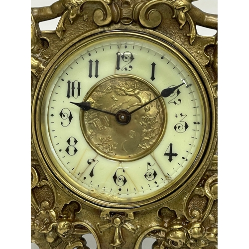 20 - An early 20th century ornate brass windup mantle clock with enamel and brass face and cherub decorat... 